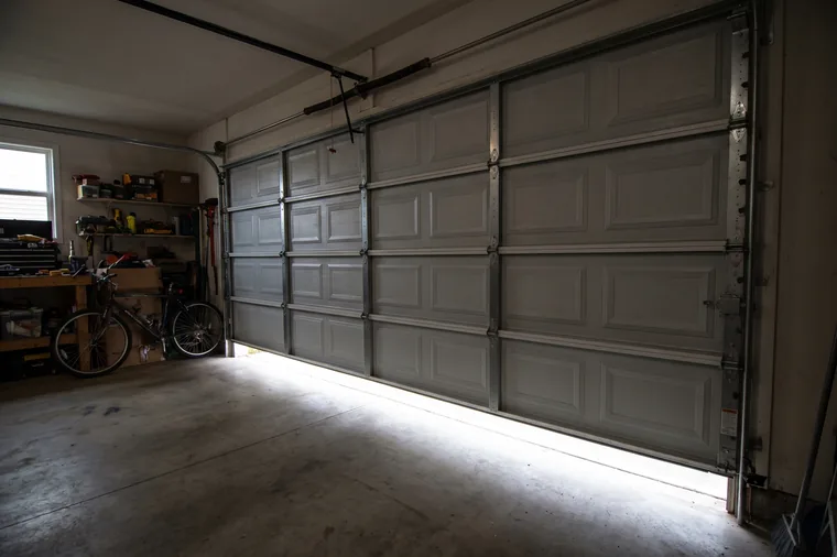 The same sectional garage door sitting square and level in the opening with every roller seated in the track
