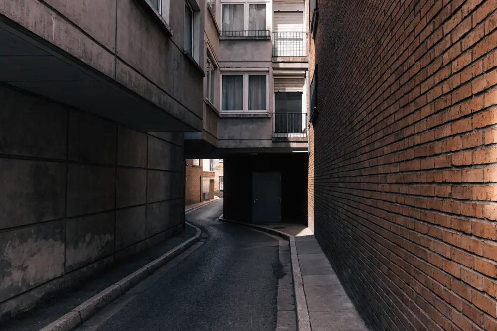 A narrow under-building garage bay on a dense block, typical of Guttenberg