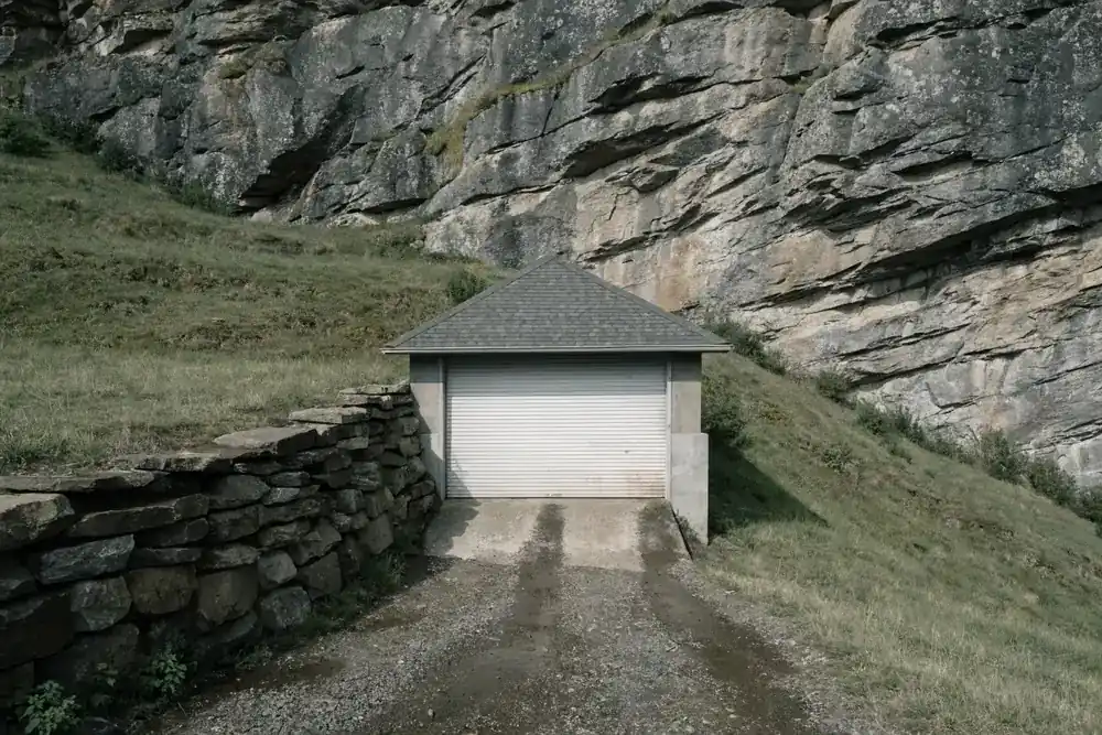 A detached garage on a sloped lot below the Palisades cliff face, typical of upper Weehawken