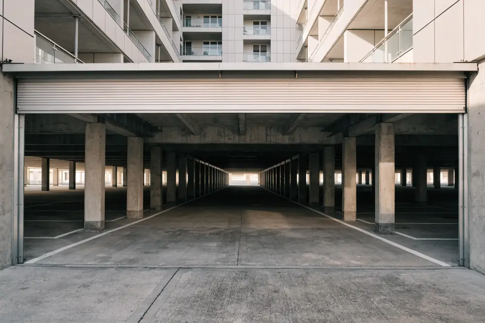 The entrance to a shared residential parking deck, typical of West New York's cliff-top buildings